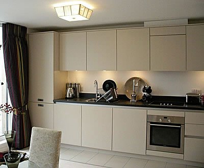 Trevor’s fitted kitchen with light cabinetry and an integrated oven